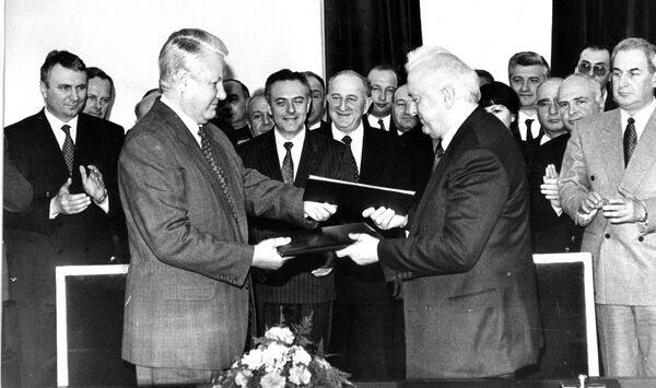 Russian President Boris Yeltsin and Georgian President Eduard Shevardnadze after signing the Treaty of Russian-Georgian Friendship, Good Neighborliness, and Cooperation. Behind Andrei Kozyrev and Jaba Ioseliani (February 3, 1994).
