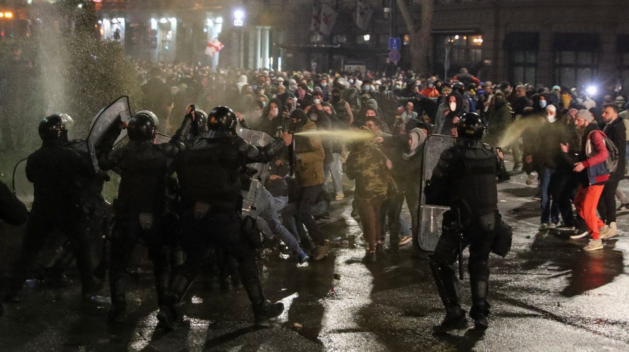 Police use tear gas to disperse protesters during a rally against a draft law on 