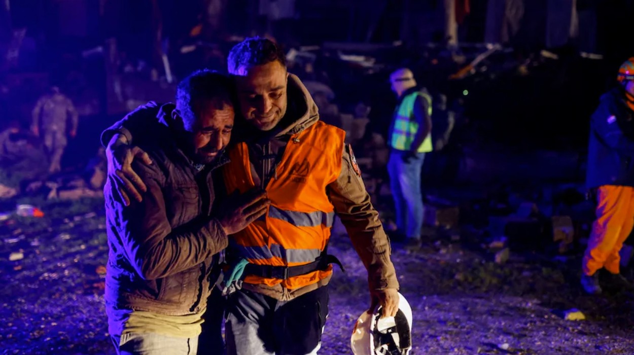 Volunteers share an emotional moment as they take part in a rescue operation in Hatay, Turkey.