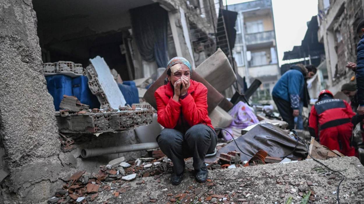 An earthquake survivor reacts as rescuers look for victims and other survivors in Hatay, Turkey, on Tuesday.
