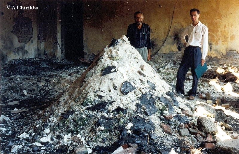 Ermolay Adzhindzhal and Abesalom Lepsaya in front of the archives turned to ashes. Photo by Viacheslav Chirikba