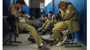 Abkhazian fighters sit in a hallway. September, 1993. 
